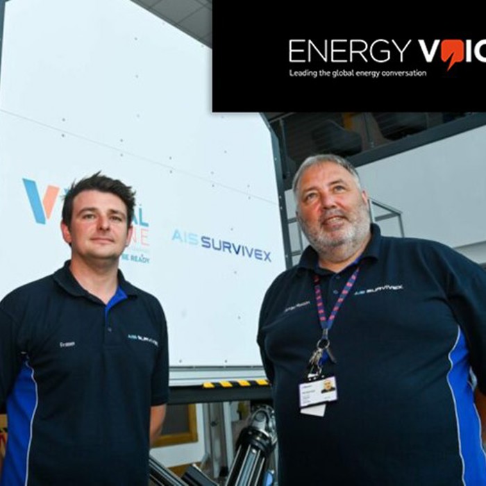 Two men in branded shirts stand in front of industrial equipment. The logo "ENERGY VOICE" and the tagline "Leading the global energy conversation" are displayed at the top right corner of the image.