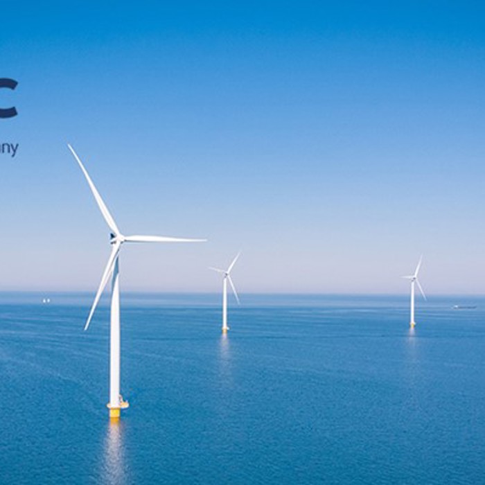 Offshore wind turbines in the ocean under a clear blue sky, with the SMC and OEG Offshore company logos in the top left corner.