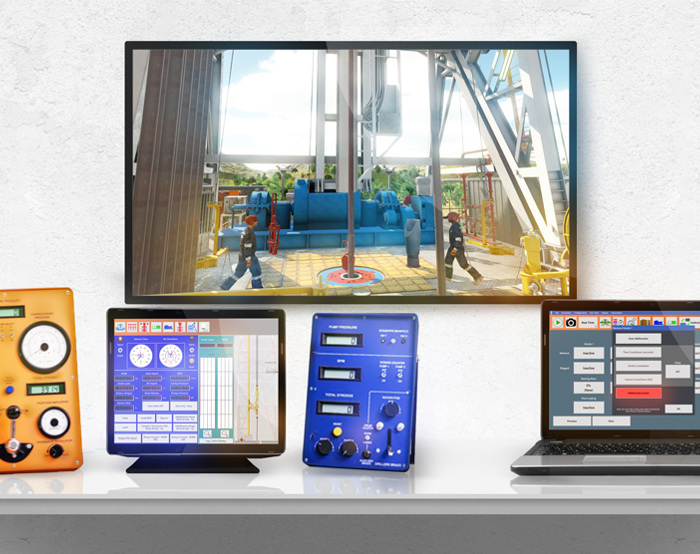 Uma secretária apresenta um monitor que mostra uma cena industrial, ao lado de um dispositivo laranja, um tablet com um ecrã azul, um dispositivo azul com botões e um computador portátil com uma interface em grelha.