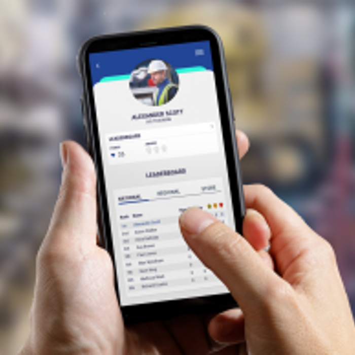 Person holding a smartphone displaying a profile page named "Alexander Nifty" with a leaderboard in the background.